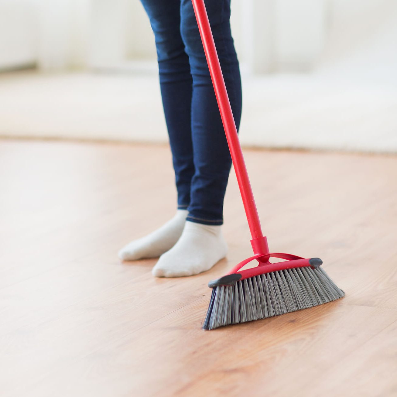 Lady sweeping Laminate floor | Homespun Furniture